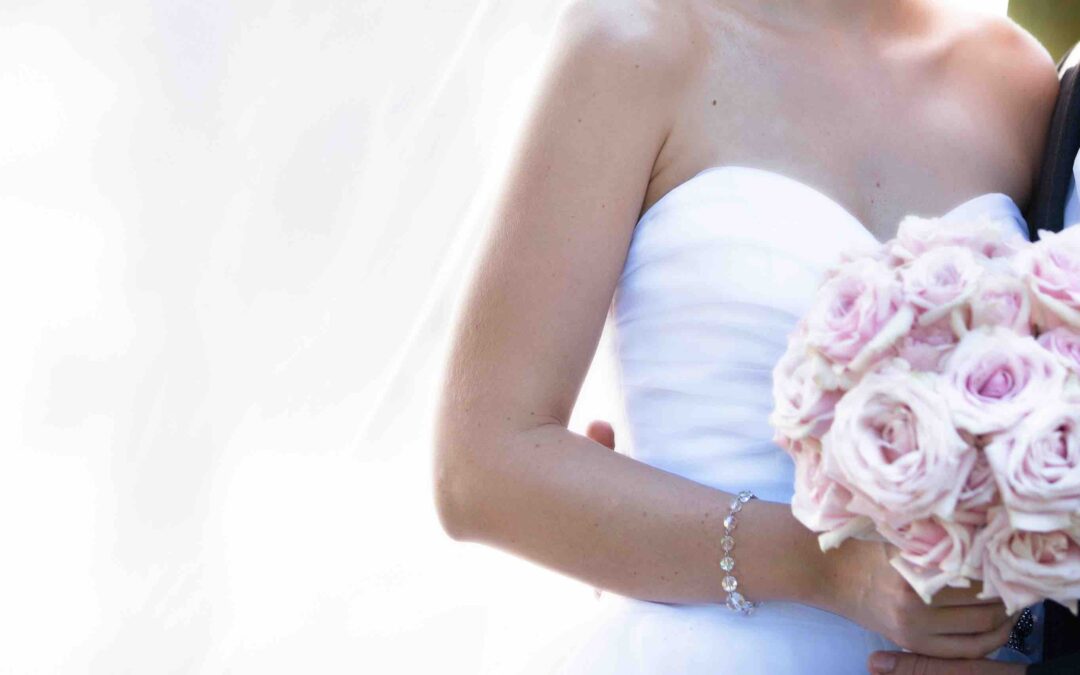 un couple marié avec la mariée qui tient un bouquet